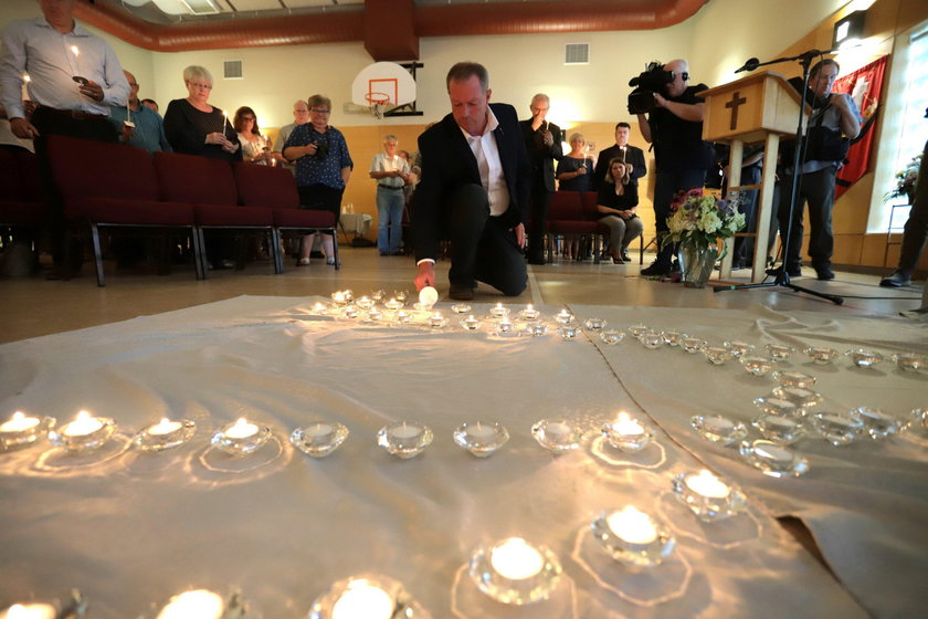 Fredericton residents pay their respects at a makeshift shrine in front of police headquarters