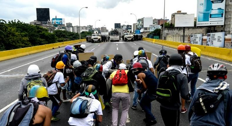 Opposition activists and riot police face off during a protest against President Nicolas Maduro, in Caracas, on May 8, 2017