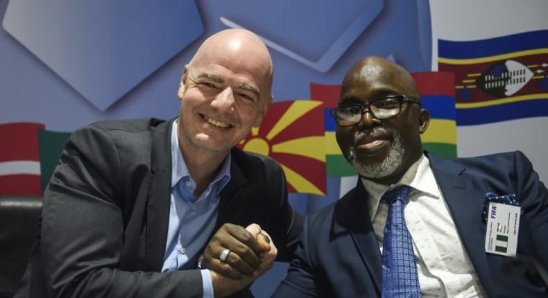 President of FIFA Gianni Infantino (L) shakes hands with President of Nigeria Football Federation Amaju Pinnick during a press conference at the end of the FIFA executive football summit in Lagos, on February 20, 2018