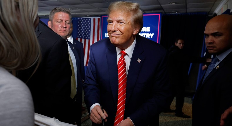 Former President Donald Trump grins as he signs an autograph after a rally in New Hampshire a day before winning the state's primary.Chip Somodevilla/Getty Images