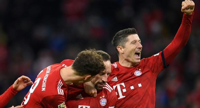 Bayern Munich's Polish striker Robert Lewandowski (R), who scored their first two goals, celebrates after Franck Ribery netted a late third in Saturday's 3-0 win against Nuremberg to lift the defending champions to third in the league table.