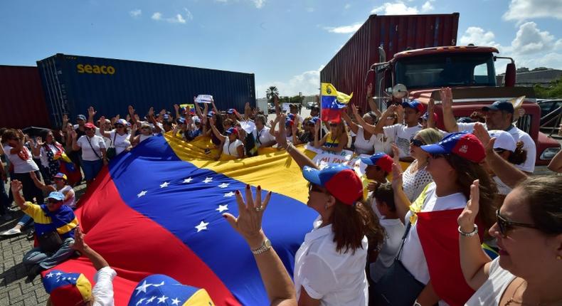 Flag-waving Venezuelan opposition supporters rallied on February 23, 2019 in the port of Willemstad, Curacao, where red trucks carried aid intended for Venezuela