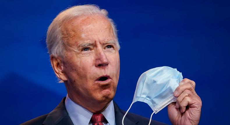 Democratic presidential nominee Joe Biden holds up a face mask at The Queen theater on October 28, 2020 in Wilmington, Delaware.
