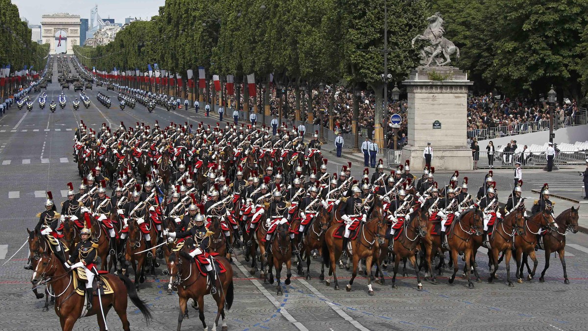 French troops of the Republican Guard on horseback attend the Bastille Day military parade on the Ch