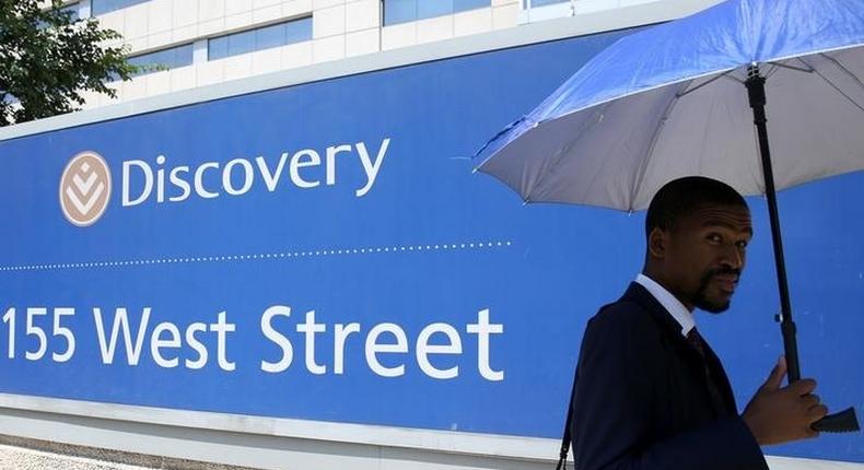 A man walks past the Discovery headquarters in Sandton, February 24, 2016. 