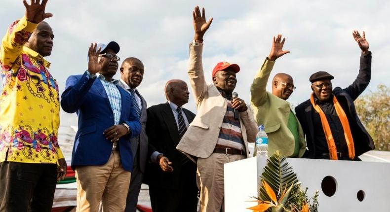 Zimbabwe's opposition joined forces on Saturday in a bid to unseat Robert Mugabe from power next year