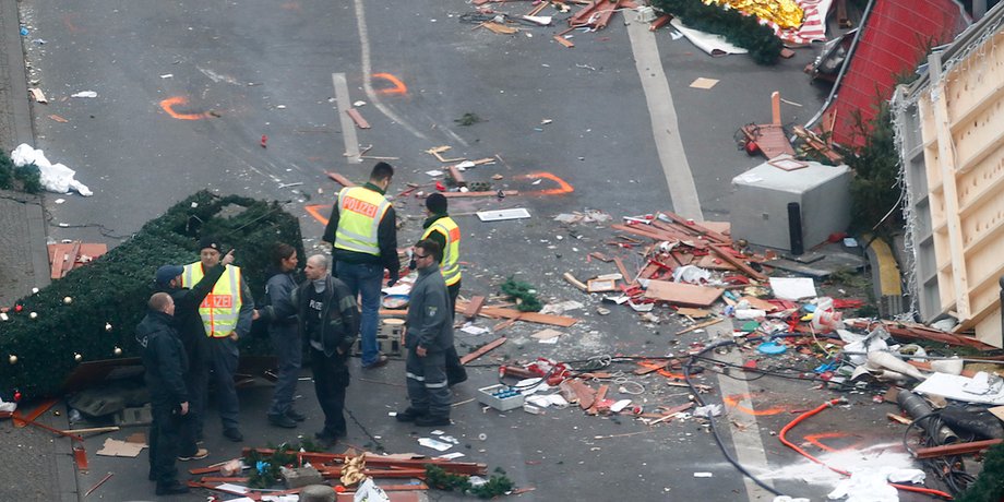 Policemen investigate the scene where a truck ploughed into a crowded Christmas market in the German capital last night in Berlin, Germany, December 20, 2016