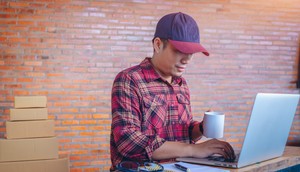 Man working in open office answering emails