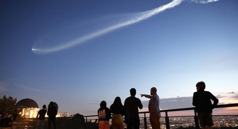 Onlookers point at the vapor jellyfish dragged behind SpaceX's Falcon9 rocket on March 19.Mario Tama/Getty Images