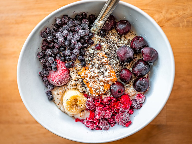 Oatmeal with frozen berries, peanut butter, and seeds.Getty