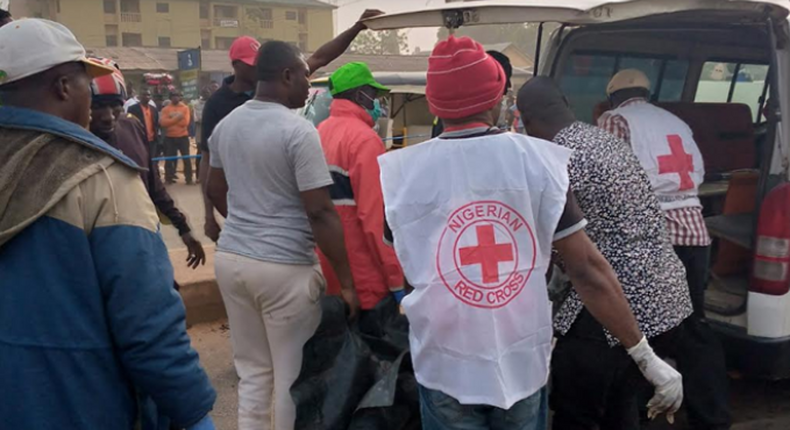 One of the victims of the gas explosion in Kaduna being rescued by men of the Nigerian Red Cross.  (Punch)