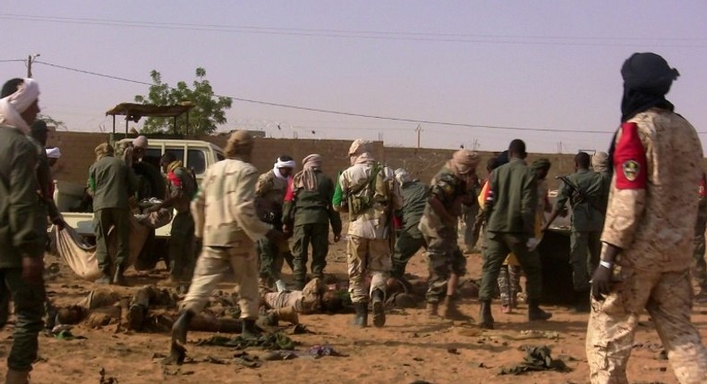 The dead and injured are evacuated following a suicide bomb attack that ripped through a camp grouping former rebels and pro-government militia in Gao, in northern Mali