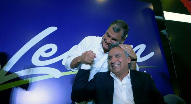 Ecuadorian President Rafael Correa (L) hugs Lenin Moreno during a post-election rally in Quito, on February 19, 2017