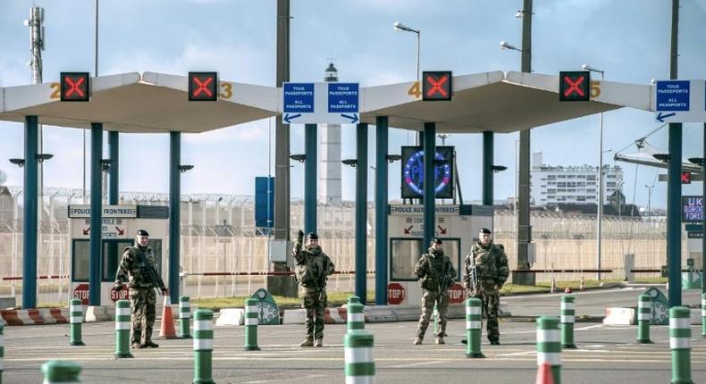 Military personnel patrol at the checkpoint of the frontier police at the northern French port city of Calais