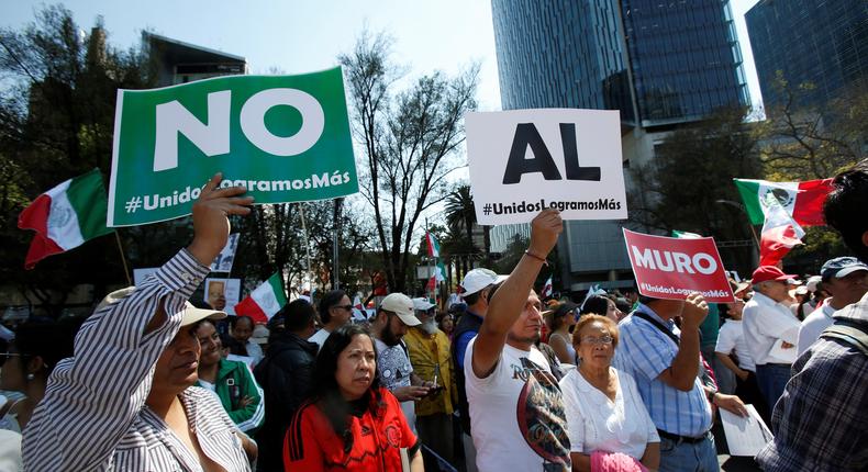 Demonstrators hold placards that collectively read No wall during a march to protest against US President Donald Trump's proposed border wall, in Mexico City, February 12, 2017.