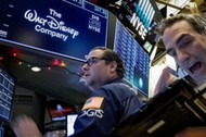 Traders work at the post where Walt Disney Co. stock is traded on the floor of the NYSE in New York