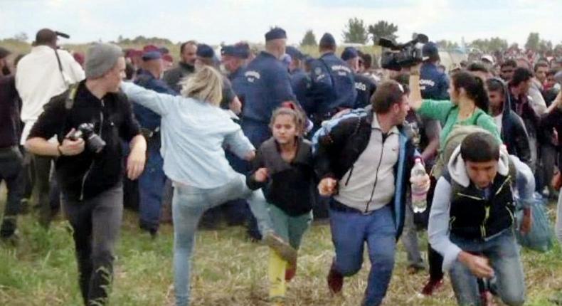 This video grab made on September 9, 2015 shows a Hungarian TV camerawoman later named as Petra Laszlo kicking a child as she run with other migrants from a police line during disturbances at Roszke, southern Hungary