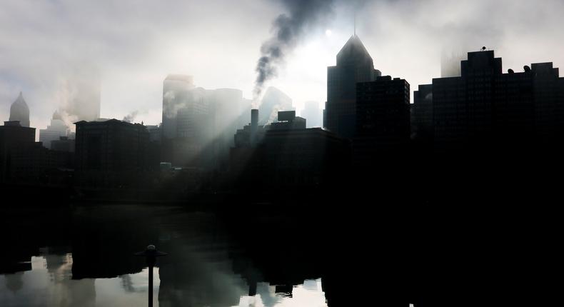 The sun rises over the skyline of Pittsburgh, Pa., reflected in the Allegheny River on a foggy morning in December 2015.