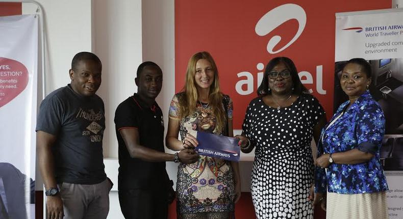 Maruf Lawal (Left), Frank Djan (2nd from left) from Airtel presents the ticket to Anas Khalid Hadi (middle), winner of the promo. With them are Mandy Johnson (2nd from right) and Georgina Acquaye (right) from British Airways.