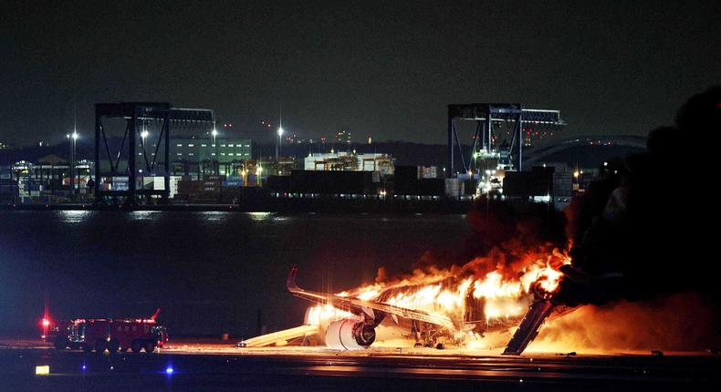 This photo provided by Jiji Press shows a Japan Airlines plane on fire on a runway of Tokyo's Haneda Airport on January 2, 2024.STR/JIJI PRESS/AFP via Getty Images