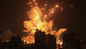 A missile explodes in Gaza City during an Israeli air strike on October 8, 2023.MAHMUD HAMS/AFP via Getty Images