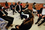 Participants attend the 'Collisions. A Virtual Reality World Premiere' event at the annual meeting o