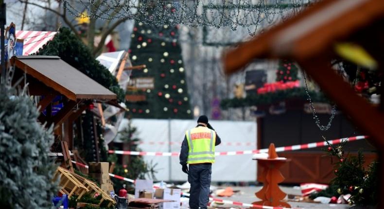 A policeman walks through the Christmas market near Berlin's Kaiser Wilhelm Memorial Church on December 20, 2016