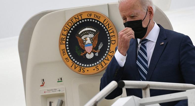 US President Joe Biden touches his face mask as he steps off Air Force One upon arrival at Hagerstown Regional Airport in Hagerstown, Maryland on April 14, 2022.