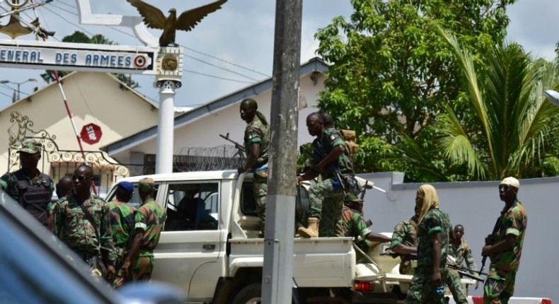 Rebellious soldiers near the entrance of Ivory Coast's army headquarters are demanding the rest of promised back pay