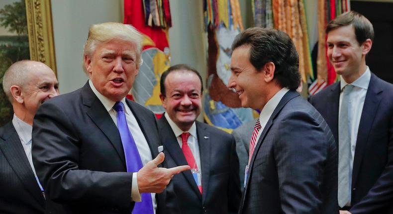 President Donald Trump points to Ford Motors CEO Mark Fields.