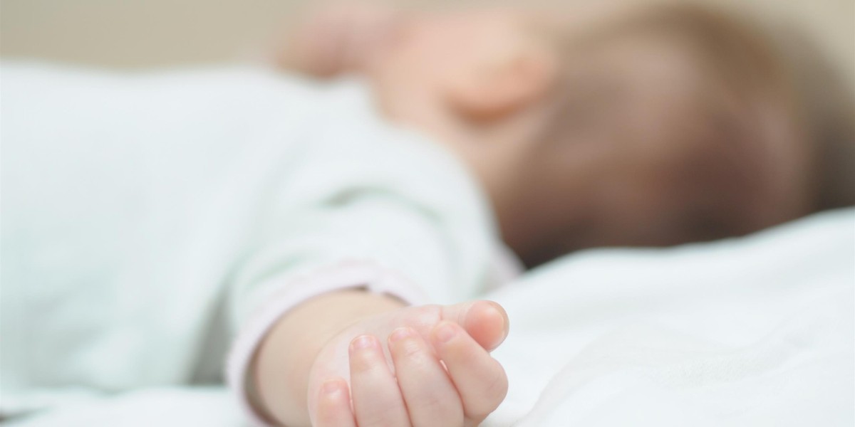 Hand of newborn 4-month baby