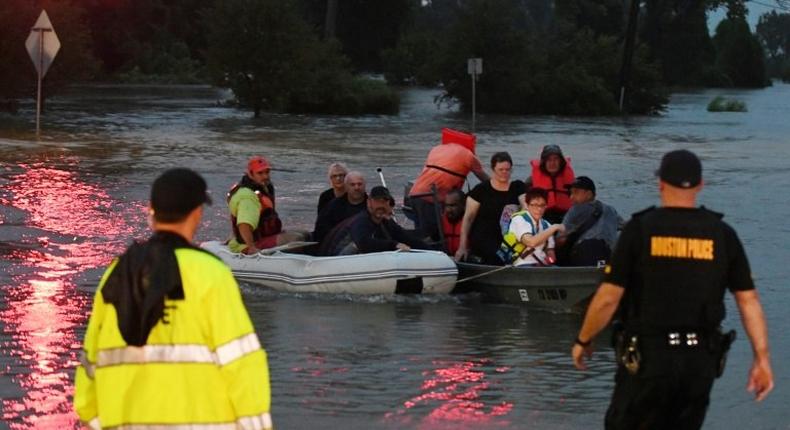 People are rescued from the Omni hotel by boat after Hurricane Harvey caused heavy flooding in Houston