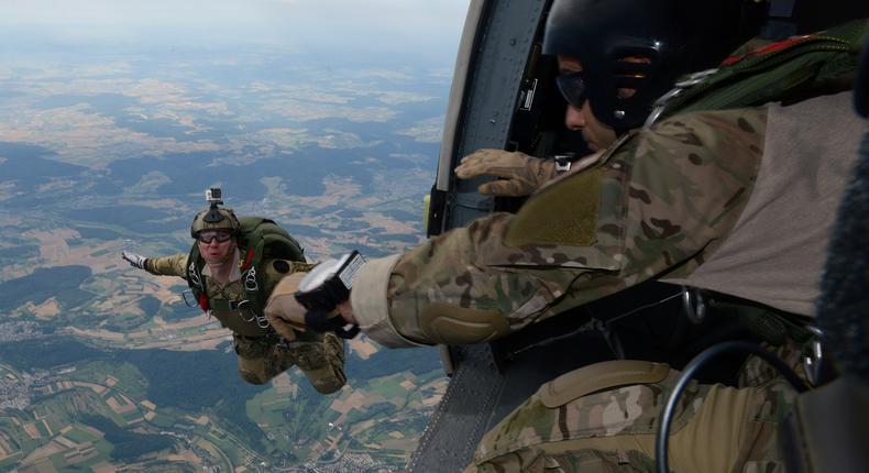 An airman with Special Operations Command Europe, jumps out of a Black Hawk helicopter, 12,000 feet above the Malmsheim Drop Zone, Stuttgart, Germany, August 17, 2016.