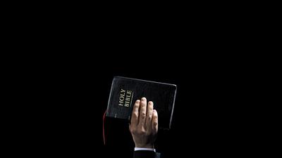 Human Hand Holding Bible