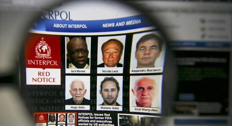 The homepage of the Interpol website is seen through a magnifying glass in this picture illustration taken in Berlin, Germany June 3, 2015. REUTERS/Pawel Kopczynski