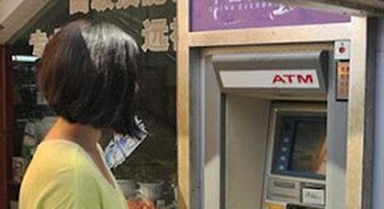 Xiao Liu standing by the ATM that electrocuted her