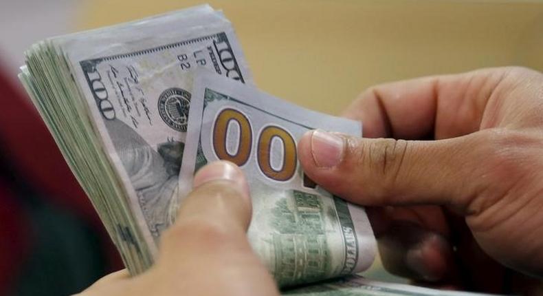 A customer counts his U.S. dollar money in a bank in Cairo, Egypt  March 10, 2016. E REUTERS/Amr Abdallah Dalsh/File Photo