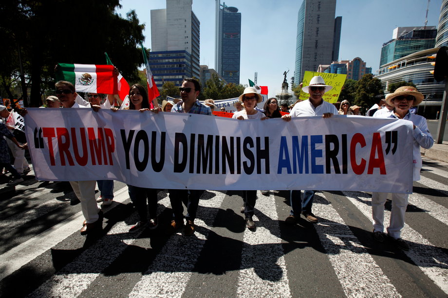 Demonstrators hold a banner during a march to protest against US President Donald Trump's proposed border wall, and to call for unity, in Mexico City, Mexico, February 12, 2017.