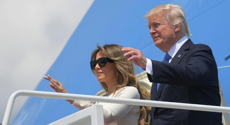 Donald Trump and his wife Melania wave before boarding Air Force One for his first trip abroad as US president