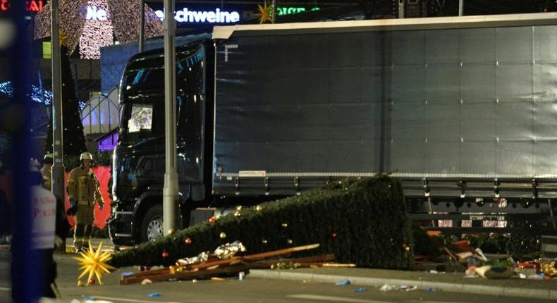 A Christmas tree lies next to a truck that crashed into a market in Berlin, on December 19, 2016