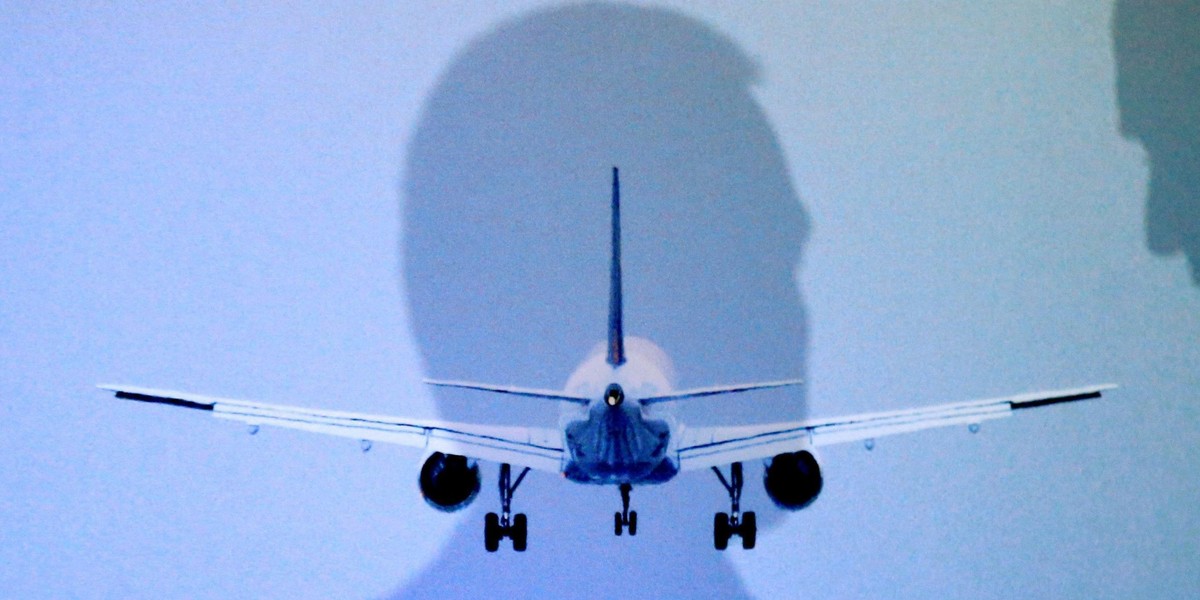 International Airlines Group CEO Walsh and Airlines for Europe A4E Managing Director Reynaert cast their shadows during a news conference in Brussels