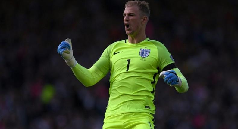 England goalkeeper Joe Hart celebrates his side's late equaliser against Scotland in Glasgow on June 10, 2017