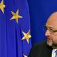 EP President Schulz looks at a european flag as he givesa statement after the conference of Presidents at the European Parliament in Brussels