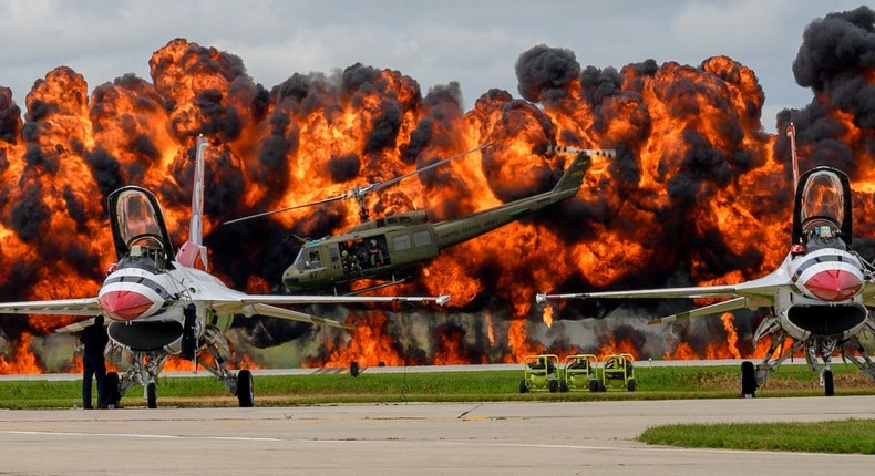 US Air Force Thunderbirds sit on the tarmac while a helicopter picks up a downed pilot amid pyrotechnics simulation during a Vietnam War reenactment at the Sioux Falls Airshow in South Dakota.Courtesy Duane Duimstra/U.S. Air National Guard/Handout via REUTERS