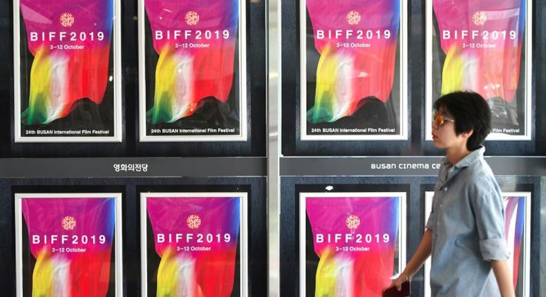 A woman walks past posters for the Busan International Film Festival at the Busan Cinema Center in South Korea