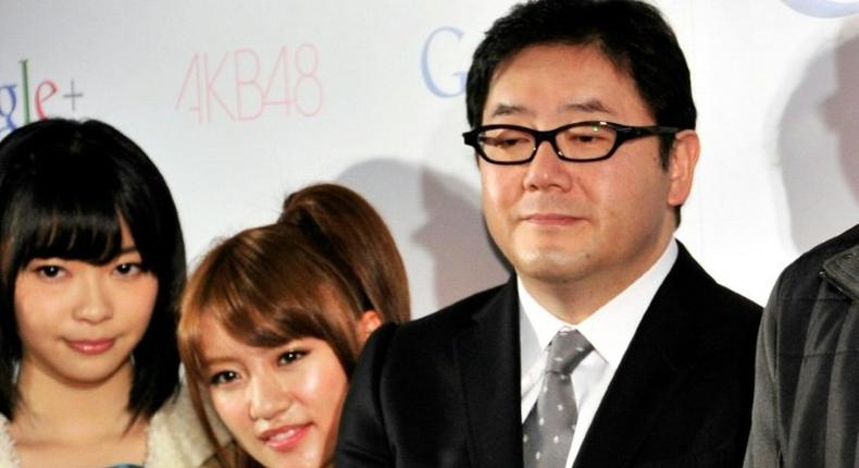 Japanese record producer Yasushi Akimoto (R) is the mastermind behind teeny-boppers Keyakizaka46 and many other similar girl bands, most famously AKB48 (members pictured, L)