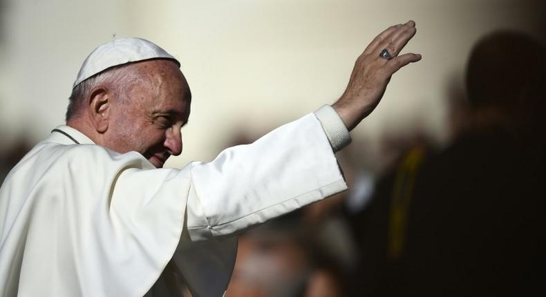 Pope Francis greets the crowd during his weekly general audience at Saint Peter's Square on November 9, 2016 at the Vatican