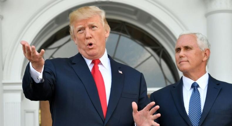 US President Donald Trump, seen here with Vice President Mike Pence, says his fire and fury warning to North Korea over its missile and nuclear programs was perhaps not forceful enough