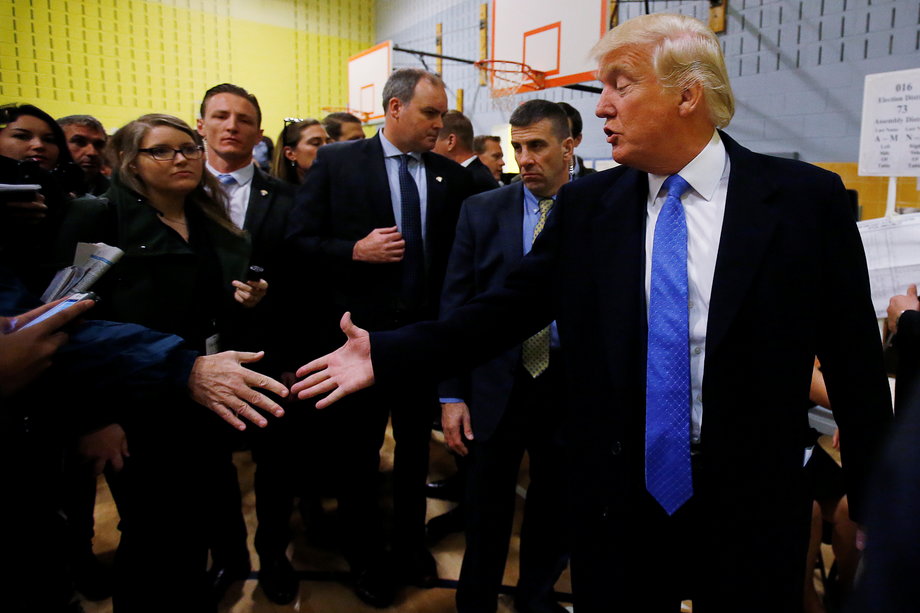 Republican presidential nominee Donald Trump shakes hands after he voted at PS 59 in New York, New York, U.S. November 8, 2016.
