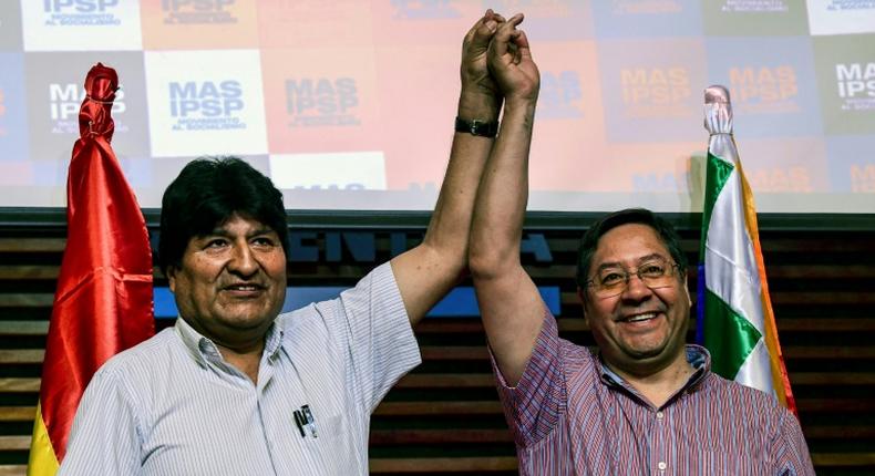 Bolivia's ex-President Evo Morales (L) and presidential candidate for his Movement for Socialism (MAS) party, Luis Arce, pose at a news conference in Buenos Aires